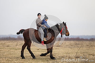 Man and his son are bareback riding an adorned horse before an Epiphany celebrati Editorial Stock Photo