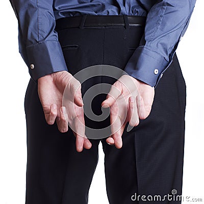 Man hold and hide on his back his cross fingers Stock Photo