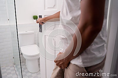 Man hold his genitals to pee Stock Photo