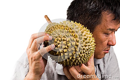 Man hold and shake durian fruit to assess its ripeness Stock Photo