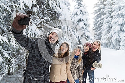 Man Hold Smart Phone Camera Taking Selfie Photo Friends Smile Snow Forest Young People Group Outdoor Stock Photo