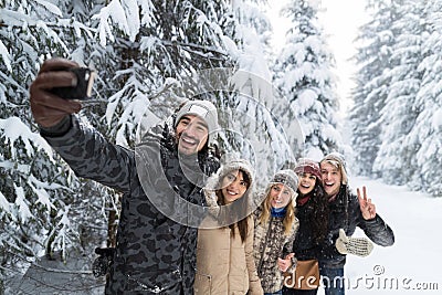 Man Hold Smart Phone Camera Taking Selfie Photo Friends Smile Snow Forest Young People Group Outdoor Stock Photo