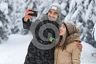 Man Hold Smart Phone Camera Taking Selfie Photo Young Romantic Couple Smile Snow Forest Outdoor Stock Photo