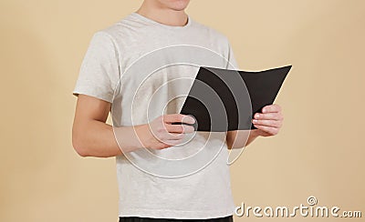 Man holding black A4 paper. Read booklet. Leaflet presentation. Stock Photo