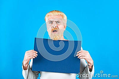 Man holding a blank billboard isolated on background. Copyspace. Business man showing thumb up holds sign board. Stock Photo