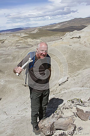 Man holding bone with dinosaur remains Stock Photo