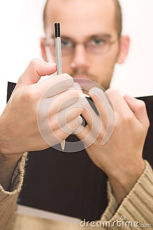 Man holding book and pencil Stock Photo