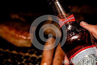 Man holding a bottle of Budweiser beer Editorial Stock Photo