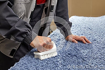 Man holding brush Removing Stain in professional cleaning service Stock Photo