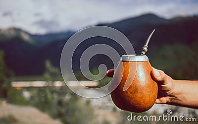 Man holding calabash yerba mate in nature. Travel and adventure concept. Latin American drink yerba mate Stock Photo