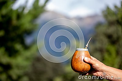 Man holding calabash yerba mate in nature. Travel and adventure concept. Latin American drink yerba mate Stock Photo