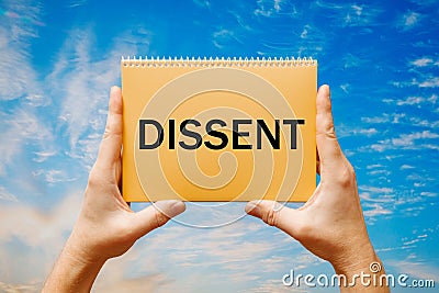 Man holding a card with text DISSENT Stock Photo