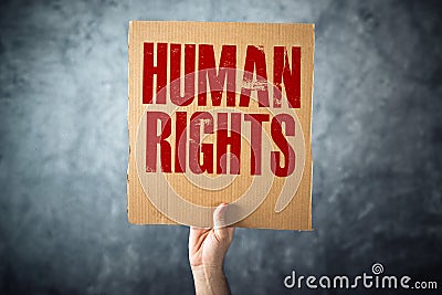 Man holding cardboard paper with HUMAN RIGHTS title Stock Photo