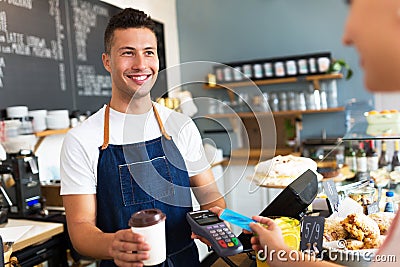 Man holding credit card reader at cafe Stock Photo