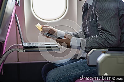 Man holding credit card and using smartphone sized sitting on machine businessman shopping online, Stock Photo