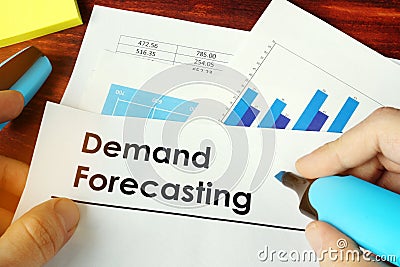 Man holding documents with Demand Forecasting. Stock Photo