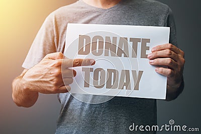 Man holding Donate today poster Stock Photo