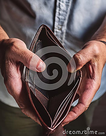 A man holding an empty brown wallet with both hands. Generative AI Stock Photo