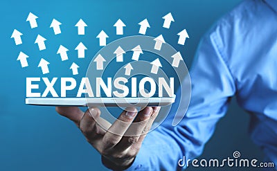 Man holding Expansion text with arrows Stock Photo