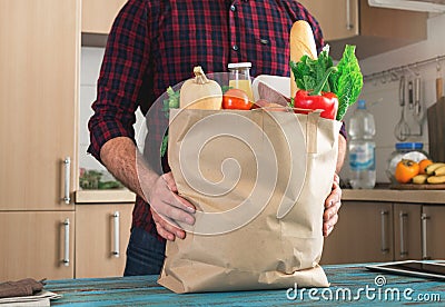 Man holding full paper bag of healthy food Stock Photo