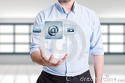 Man holding futuristic contact us floating icons Stock Photo