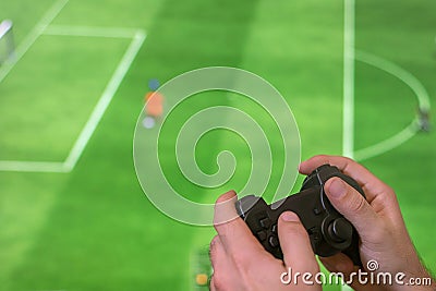 Man Holding game controller joystick while playing console game. Stock Photo