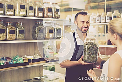 Man holding glass can with dried herbs Stock Photo