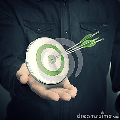 Man Holding Green Target - Marketing Solutions Concept Stock Photo