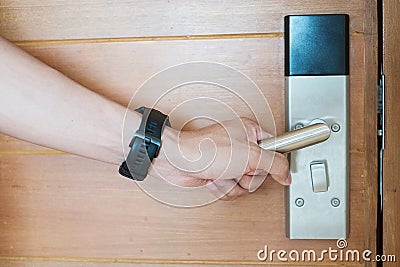 Man holding handle of smart digital door lock between open or close the door. Technology, electrical and lifestyle concepts Stock Photo