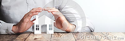 Protecting Hands Over House Stock Photo