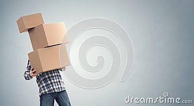 Man holding heavy cardboard boxes relocation, moving house or courier delivery Stock Photo