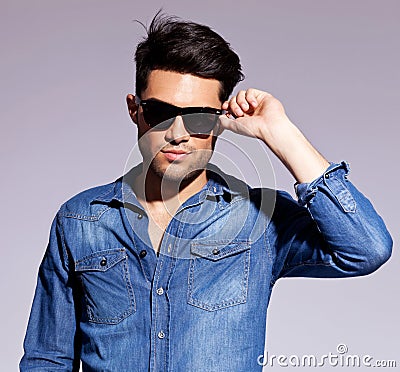 Man holding his fashionable sunglasses Stock Photo