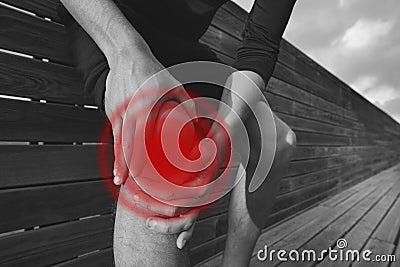 Man holding his painful knee. Exercise knee injury and pain. Injury from workout Stock Photo