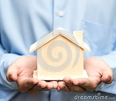 Man holding house representing home ownership Stock Photo