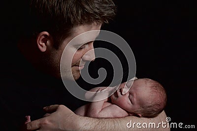 A man holding an infant Stock Photo