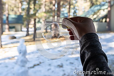 Man holding inflated soap bubble Stock Photo