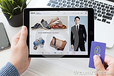 Man holding iPad Pro with Online shopping service Amazon Editorial Stock Photo