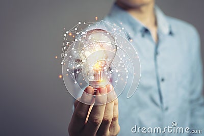 Man holding light bulbs, ideas of new ideas with innovative technology and creativity. concept creativity with bulbs that shine Stock Photo