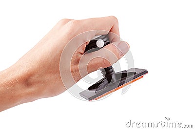 Man holding a modern professional legal office rubber stamp about to stamp sign a document, hand isolated on white, cut out. Stock Photo