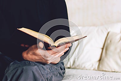 Man holding Open book in hands. Male hands hold a hardcover book. Education, literature, knowledge, reading concept. Copy space Stock Photo