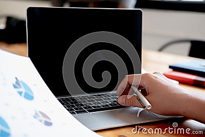 Man holding pen in hand and use laptop Stock Photo