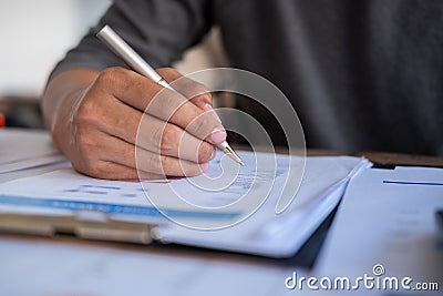 Man holding pen to point in paperwork, meeting concept Stock Photo