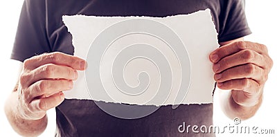 Man holding piece of torn blank paper as copy space Stock Photo