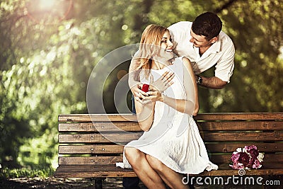 Man holding red box with ring making propose to his girlfriend Stock Photo