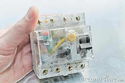 Man holding a residual current device in modular design. Stock Photo