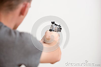 Man holding a revolver in hands ready to shoot. Stock Photo