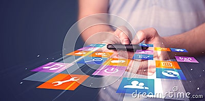 Man holding smart phone with colorful application icons Stock Photo