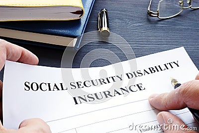 Man holding Social Security Disability Insurance SSDI policy. Stock Photo
