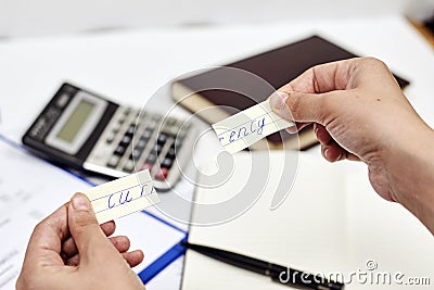 Man holding a torn piece of paper with the word currency on it. Stock Photo