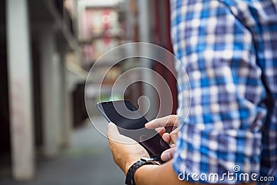 Man holding, touching or working on mobile phone with blank black screen with copy space. Male hands with touch screen smart Stock Photo